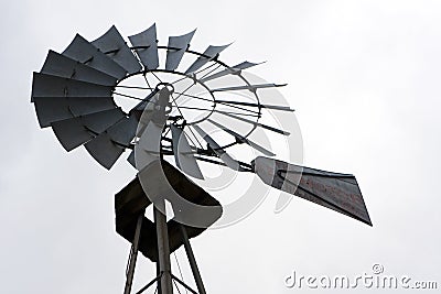 back lit portrait of an Old Fashioned Farm Windmill.