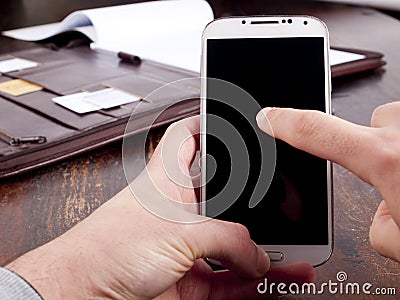 Old fashioned leather folder with modern phone