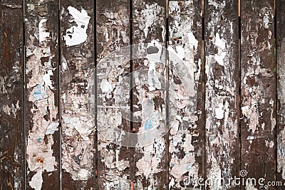 Old fence texture with scraps of paper ads
