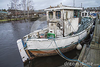 The boat is built of wood and is in dire need to maintenance, repair