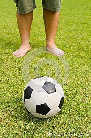 Old football on green grass