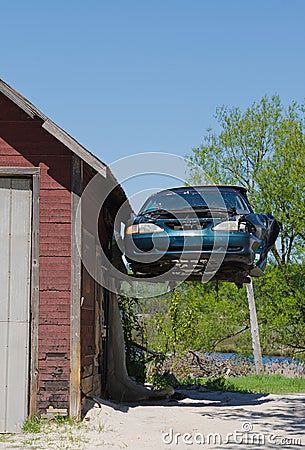 Old Ford Mustang hanging from Garage