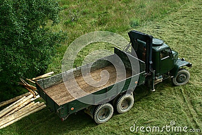 Old green army truck modified for timber transport