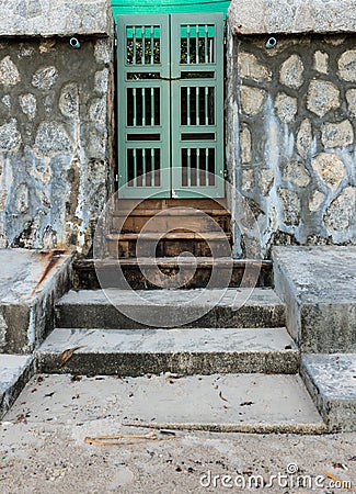 Old green door and stone wall
