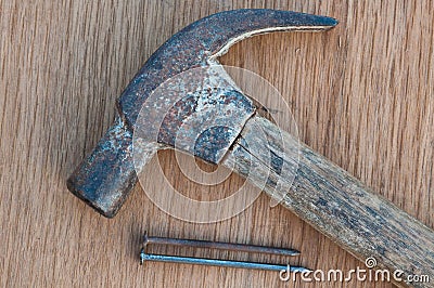 Old hammer with nail