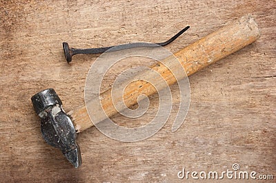 Old hammer and a rusty nail