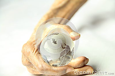 Old hand held a crystal clear globe