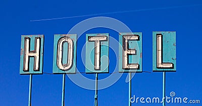 Old Hotel Sign And Airplane Isolated On Blue