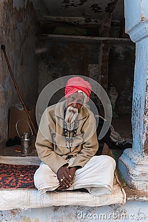 An old Indian man with a red turban