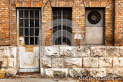 Old industrial building exterior wall, door and window