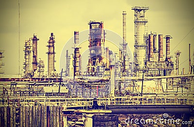 Old industrial plant with gray sky, vintage retro style.