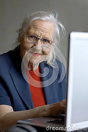 Old lady typing on laptop