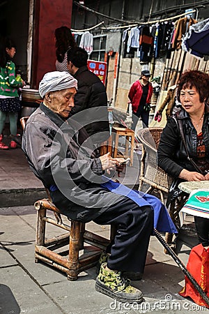 The old man counting money in yuantong town,insichuan,china