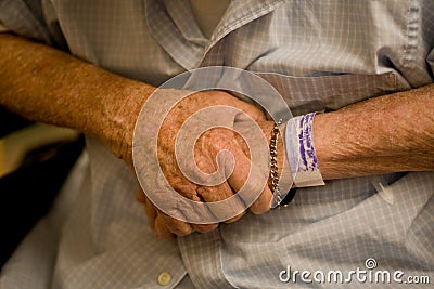 Old man s hands with hospital wristband