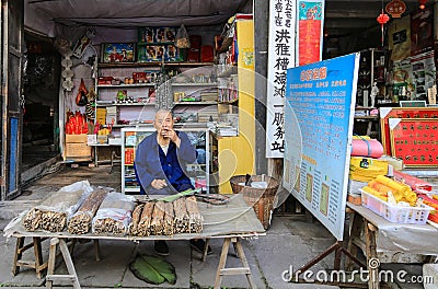 Old man selling tobacco in luoba town,sichuan,china