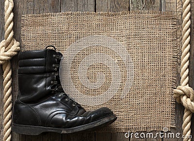 Old military shoes on wooden boards