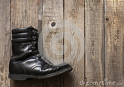 Old military shoes on wooden boards