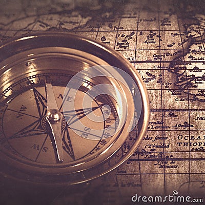 Old nautical compass over the map