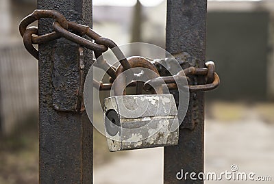 Old padlock on rusty chain