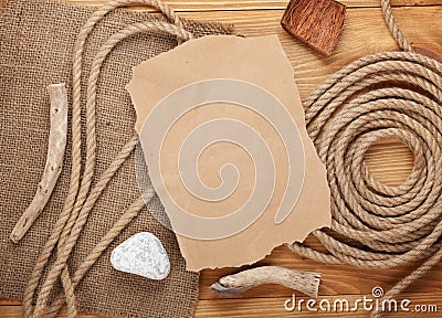 Old paper and rope on wooden textured background