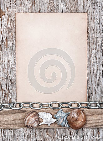 Old paper, seashells and metal chain on the old wood