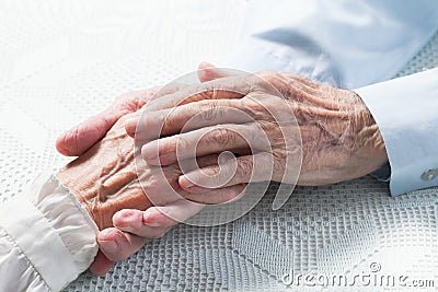 Old people holding hands
