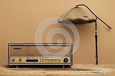 Old radio on wooden table with floor lamp