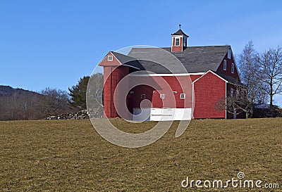 Old red barn in field
