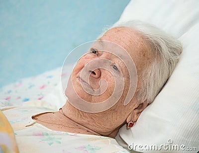 Old sick woman lying at bed