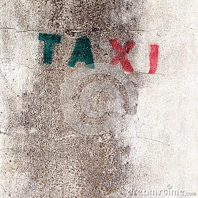 Old stencil taxi sign on the wall