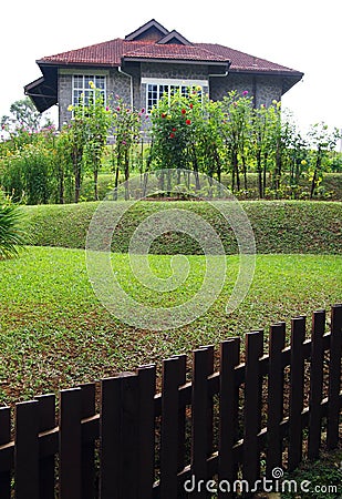 Old stone house with terraced garden and fence