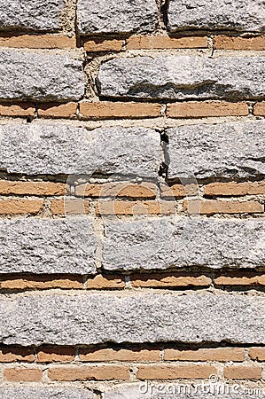 Old stone wall with bricks closeup