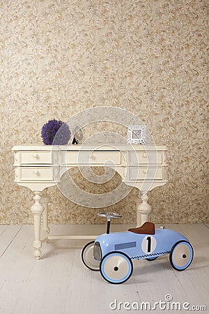 Old stylized interior with white table and old blue car toy