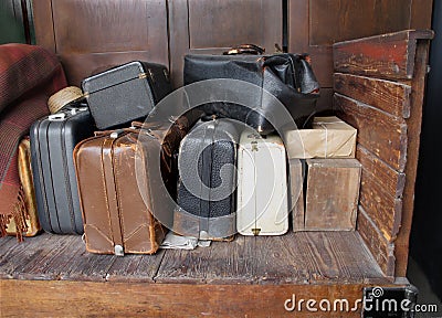 Old suitcases on an old wooden cart