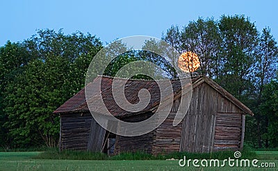 Old swedish barn on field during moonlight