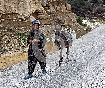 Old Turkish women walking on the road.