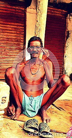 An old Indian village guy chilling after hard work