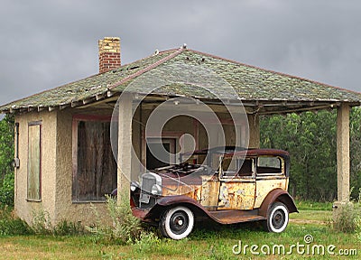 Old vintage car by a small building