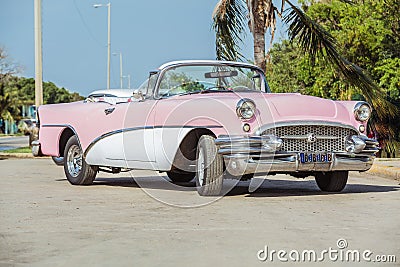 Old vintage pink & white classic car