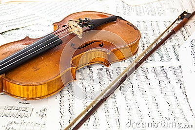 Old violin lying on the sheet of music