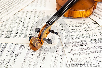 Old violin lying on the sheet of music