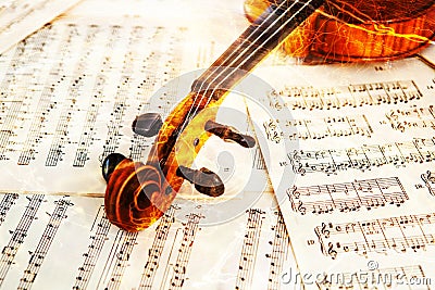 Old violin lying on the sheet of music