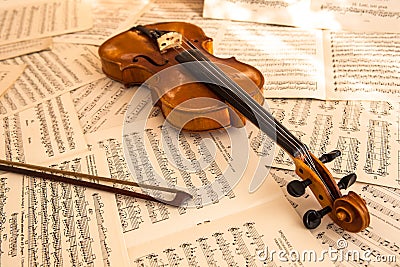 Old violin lying on the sheet of music