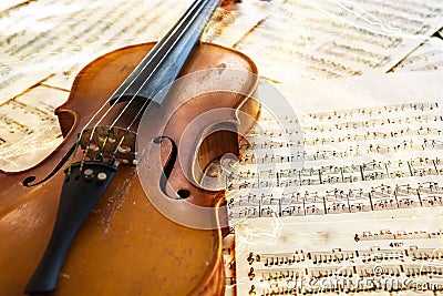 Old violin lying on the sheet of music