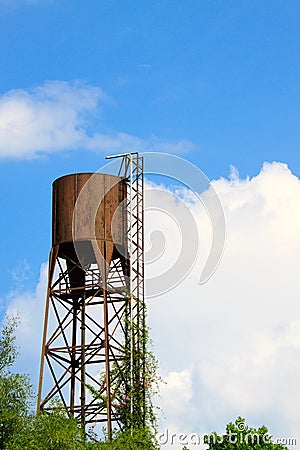 Old water tank tower on blue sky