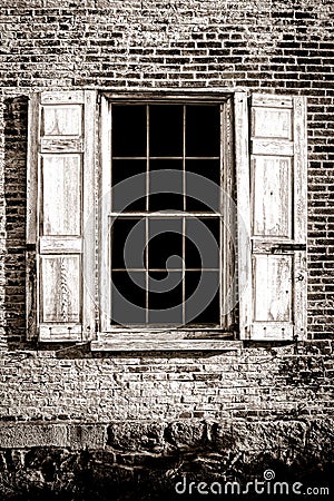 Old Window and Wood Shutters on Ancient Brick Wall