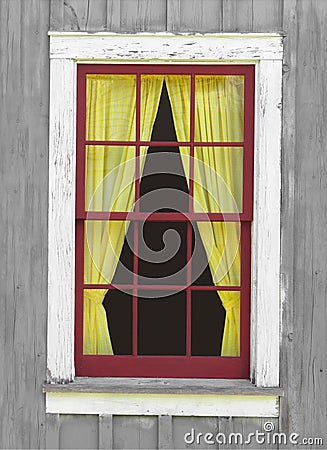 Old window with a yellow curtain.