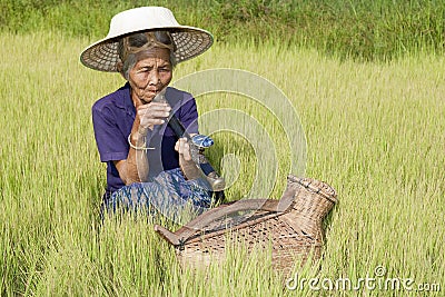 Old woman Asia smoking opium pipe