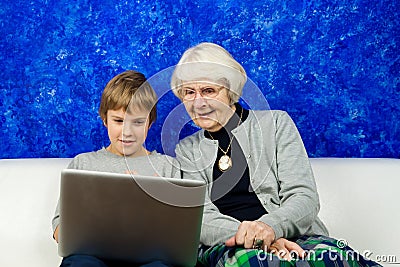 Old woman and boy looking at a laptop