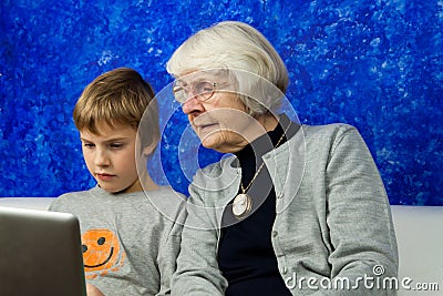 Old woman and boy looking at a laptop